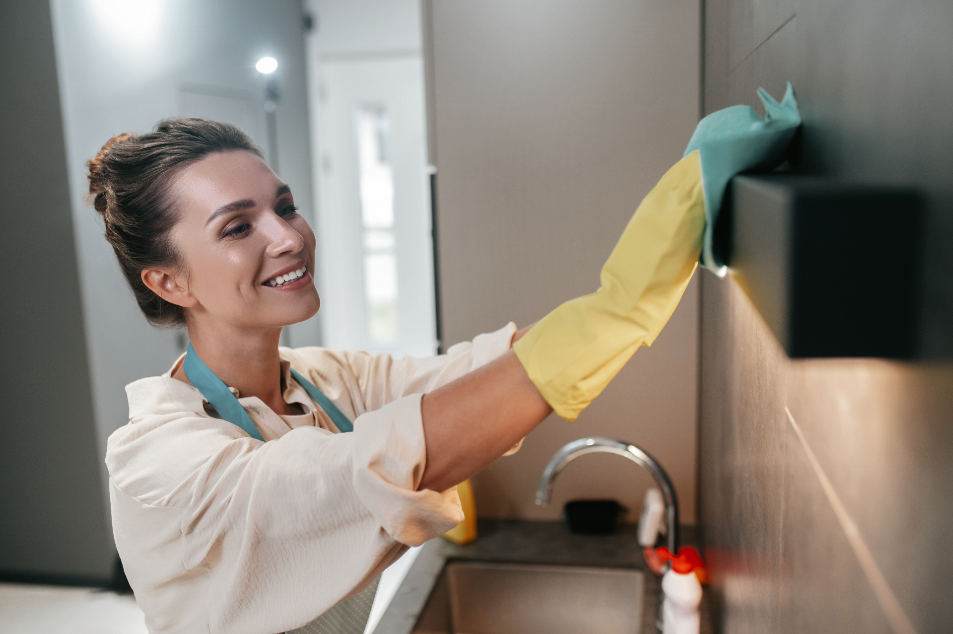 Two cleaners in a bright kitchen